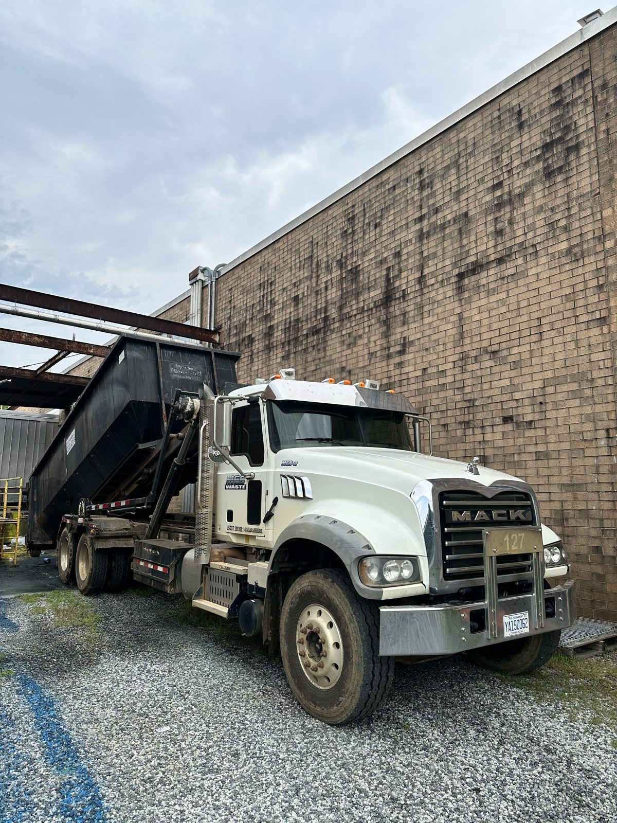 MGS Waste roll-off truck with an empty container ready for delivery